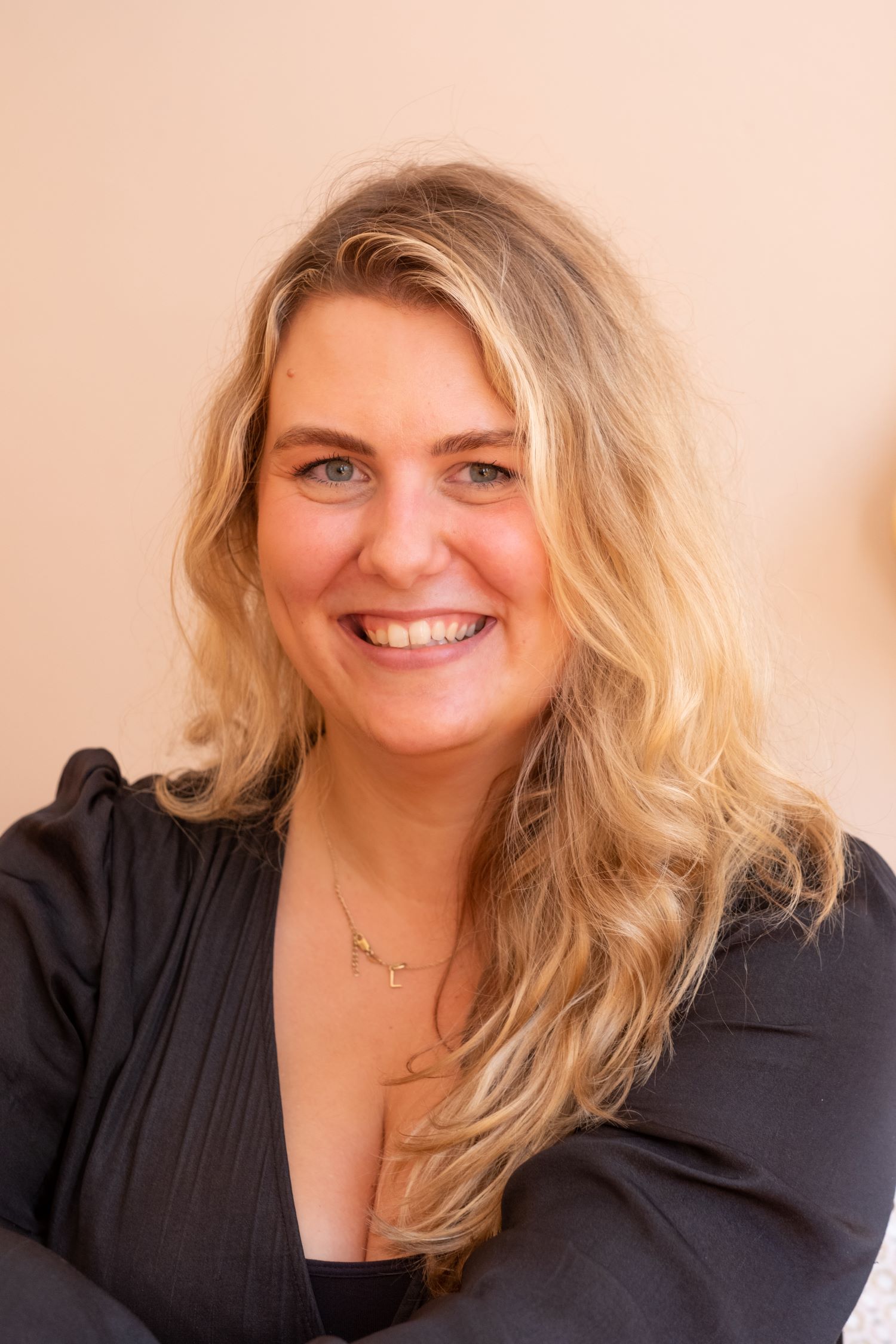 frontal portrait, blonde woman, smiling, natural light